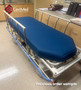Hill-Rom P8000 refurbished in the lobby of a medical clinic with blue mattress.