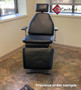 MTI 530 refurbished with black upholstery in a medical exam room with brown flooring.