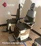 Two dark gray MTI 424 tri-power exam chairs with adjustable headrests and footrests, positioned side by side in a clinical room setting.