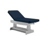 Oakworks PF250 Series exam table with navy blue upholstery and gray adjustable-height base.