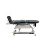 Flat position of the DJO Global Moveo 8080, featuring cushioned sections, safety straps, and a mobile base for secure patient positioning during therapy.