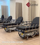 Many refurbished Stryker 1001 in a clinic room with a black mattress.