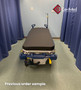 Refurbished Stryker 1001 in a clinic room with a black mattress.