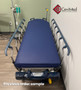 Refurbished Stryker 1015 in a clinic room with a blue mattress.
