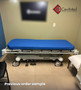 Refurbished Stryker 721 in a medical room with a blue mattress.
