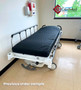 Refurbished Stryker 721 in a medical room with a black mattress.