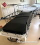 Two refurbished Stryker 721 in a medical room with black mattresses.