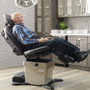 Older man reclining comfortably on a black Midmark 630 HumanForm medical procedure chair.