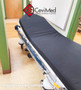 Refurbished Stryker 1004 in a clinic hallway with black mattress.
