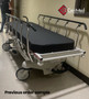 Refurbished Stryker 1004 in a clinic hallway with black mattress.