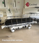 Refurbished Stryker 1004 in the lobby of a medical clinic with black mattress.