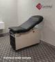 Midmark 104 round top exam table with black upholstery.
