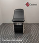 Midmark 104 round top exam table with black upholstery.