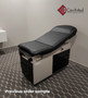 Midmark 104 round top exam table with black upholstery.