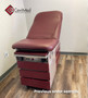Midmark 104 round top exam table with wine upholstery.