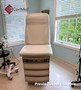 Midmark 104 round top exam table with cream upholstery.