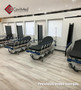 Several refurbished Stryker 1007s in a clinic room with black mattresses.