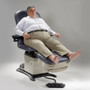 A patient seated on a Midmark 647, demonstrating its bariatric support capability with an extended footrest and side control panel visible.