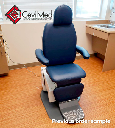 Blue Global SMR MAXI 2700 exam chair with padded headrest, backrest, armrests, seat, and leg rest, placed on a wood-look floor in a clinical room with cabinetry and sink in the background.