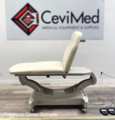 Ritter 244 power exam table with light beige upholstery in a clinical setting.