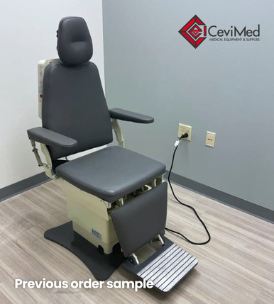 MTI 423 Power ENT Chair in dark gray upholstery, set against a light gray wall and wood-look flooring in a modern exam room.