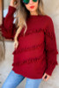 Burgandy sweater, diagnal fringe detail design.