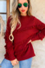 Burgandy sweater, diagnal fringe detail design.