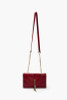 Red quilted crossbody envelope shape gold hardware front tassel detail