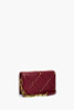 Dark Red Baguette Crossbody Premium Vegan Leather Quilted Stitching Accessorized with Gold Rhinestone Studs Chain Links.