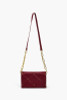 Dark Red Baguette Crossbody Premium Vegan Leather Quilted Stitching Accessorized with Gold Rhinestone Studs Chain Links.