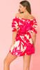Pink and red printed romper off the shoulder. Bright vivid colors, elastic waist with a waist tie.