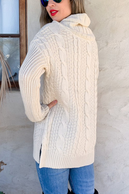Ivory sweater braided detail design very flattering side slits at the hips, high neck or fold down. Super soft, longer sweater sits below the hips and longer sleeves for that ultra coziness.
