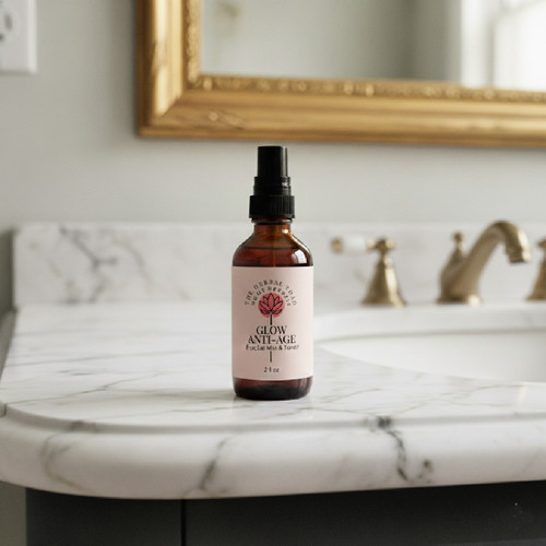 Glow Anti Age Mist 2 ounce bottle setting on bathroom counter