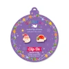Santa & Santa Hat Mix & Match Clip-On Earrings displayed on purple Girl Nation Christmas ornament card
