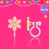 Girl Nation pink snowflake clip-on earring showing delicate hand-painted enamel details, gold-tone outlines and transparent silicone clip on festive pink background