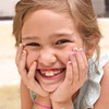 Girl smiling and wearing Girl Nation Lil' Fingers Nail Art stickers