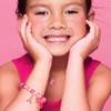 Girl wearing Girl Nation Sweetheart Love pink charm bracelet