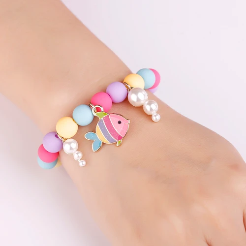 Rainbow Fish bracelet with pastel beads and pearl-like bubble charms on wrist