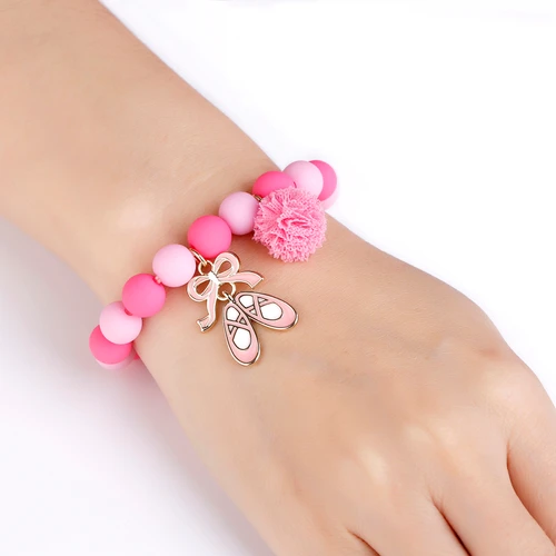 Ballet Shoes charm bracelet with pink beads and pom-pom on wrist