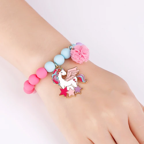 Magical Unicorn bracelet with winged unicorn, stars and pink pom-pom on wrist