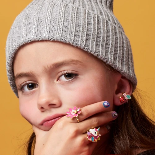 Girl wearing Girl Nation Petal Party and Unicorn adjustable flower ring