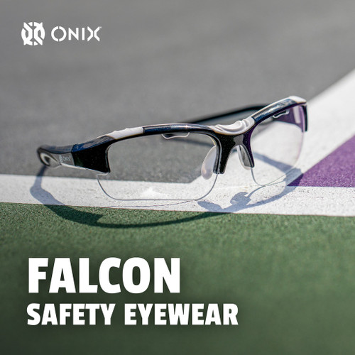 Onix Falcon pickleball eyewear resting on a court line, angled close-up with the Falcon branding visible