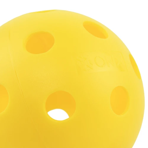 Close-up detail of an Onix Fuse Indoor Yellow pickleball showing the embossed Onix logo between the holes