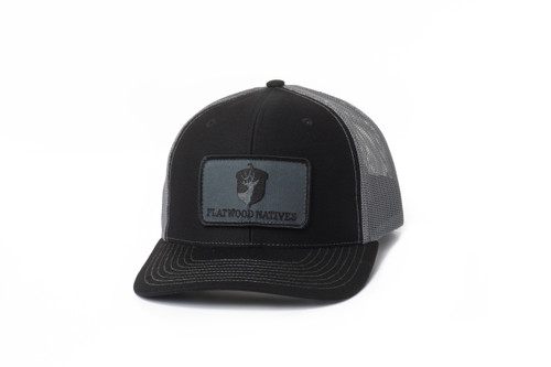 Black trucker hat with grey mesh back and full Flatwoods patch logo