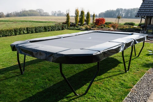 Akrobat Challenger Plus 17x10 trampoline in a garden setting without net