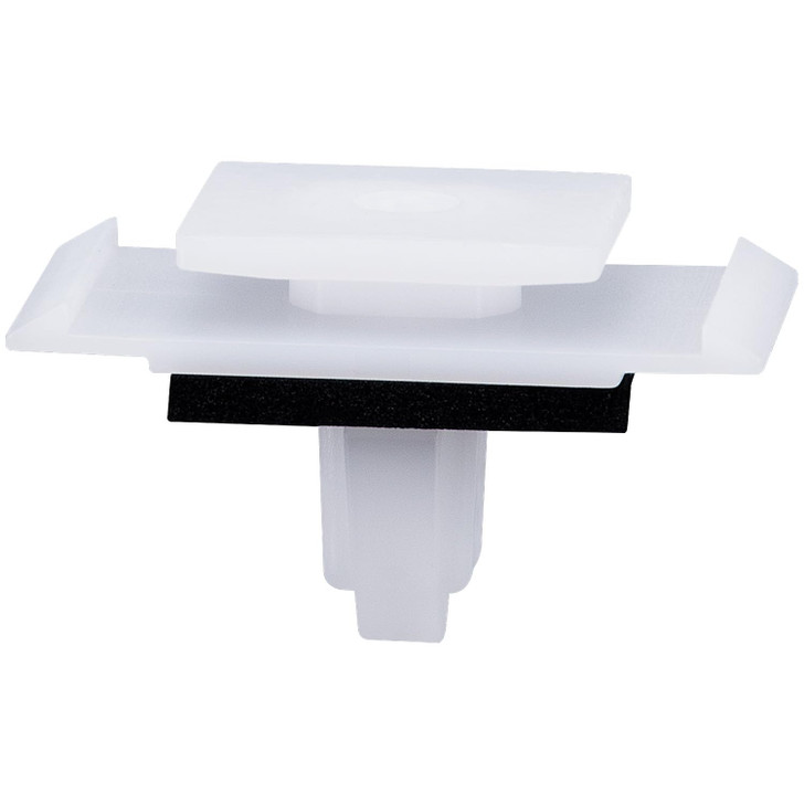 White plastic automotive rocker panel moulding clip with foam sealing pad and push-in stem, rectangular top with side locating tabs.