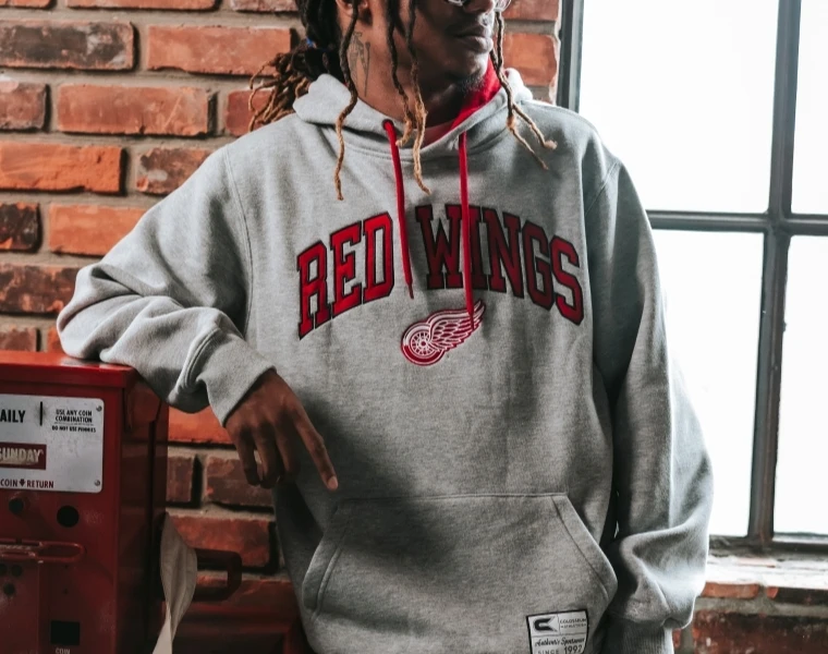 Man smiling while wearing Columbus Blue Jacket gear