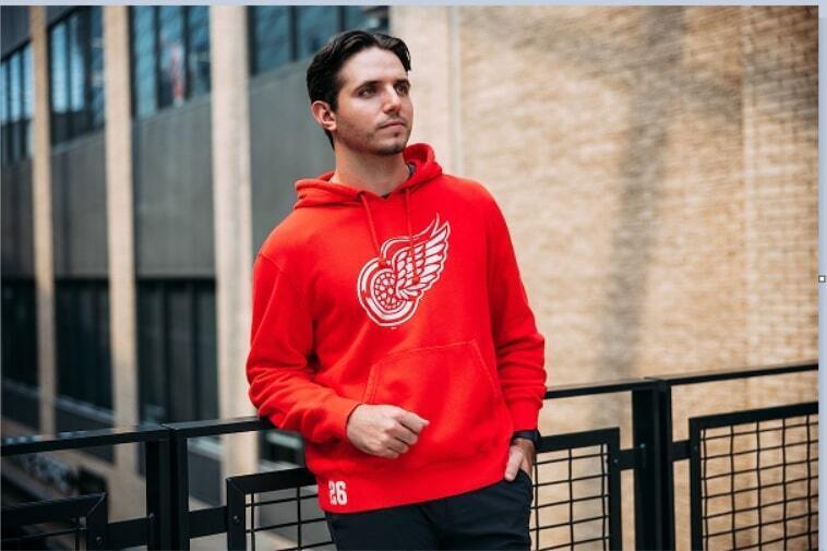 Man smiling while wearing Columbus Blue Jacket gear