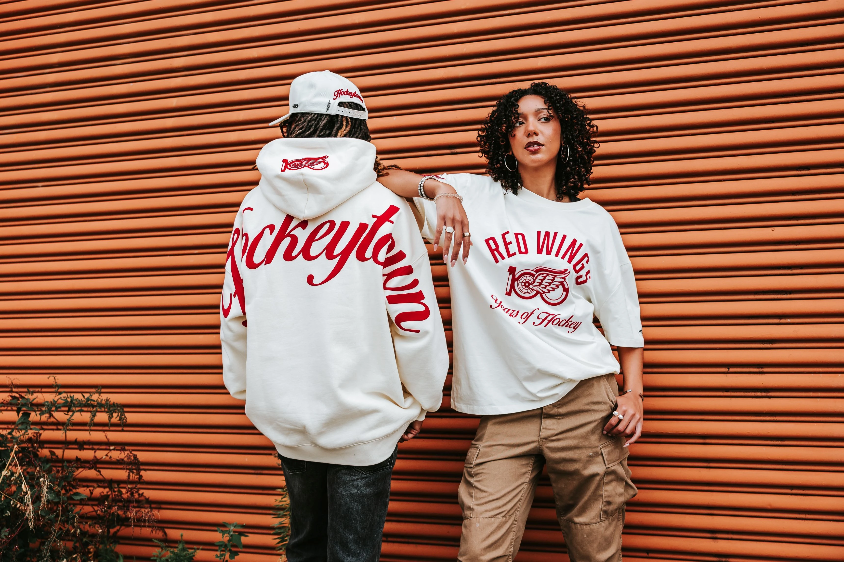 Male and female modeling new Pro Standard Centennial sweatshirt and t-shirt data-size=