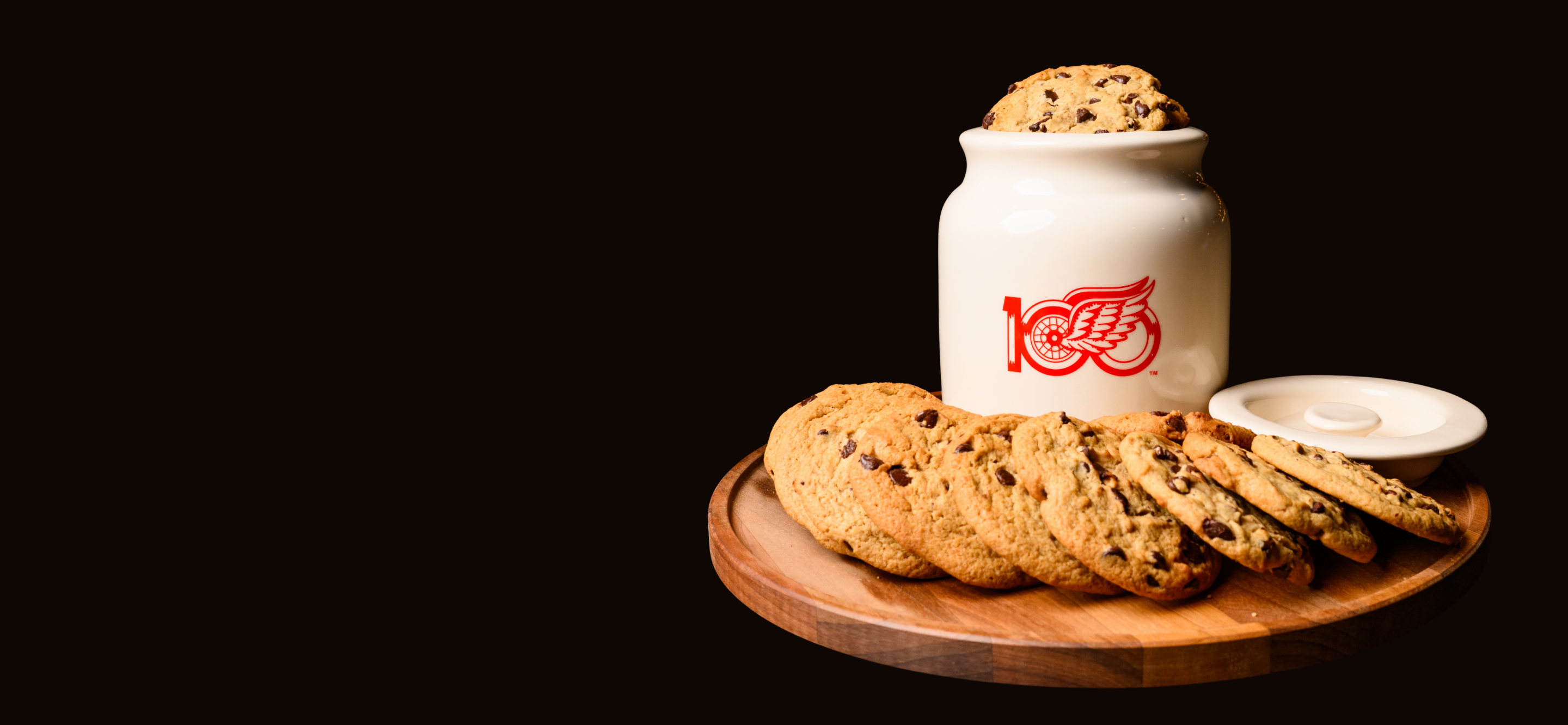 Picture of Limited Edition Centennial Cookie Jar, surrounded by chocolate Chip Cookies. data-size=